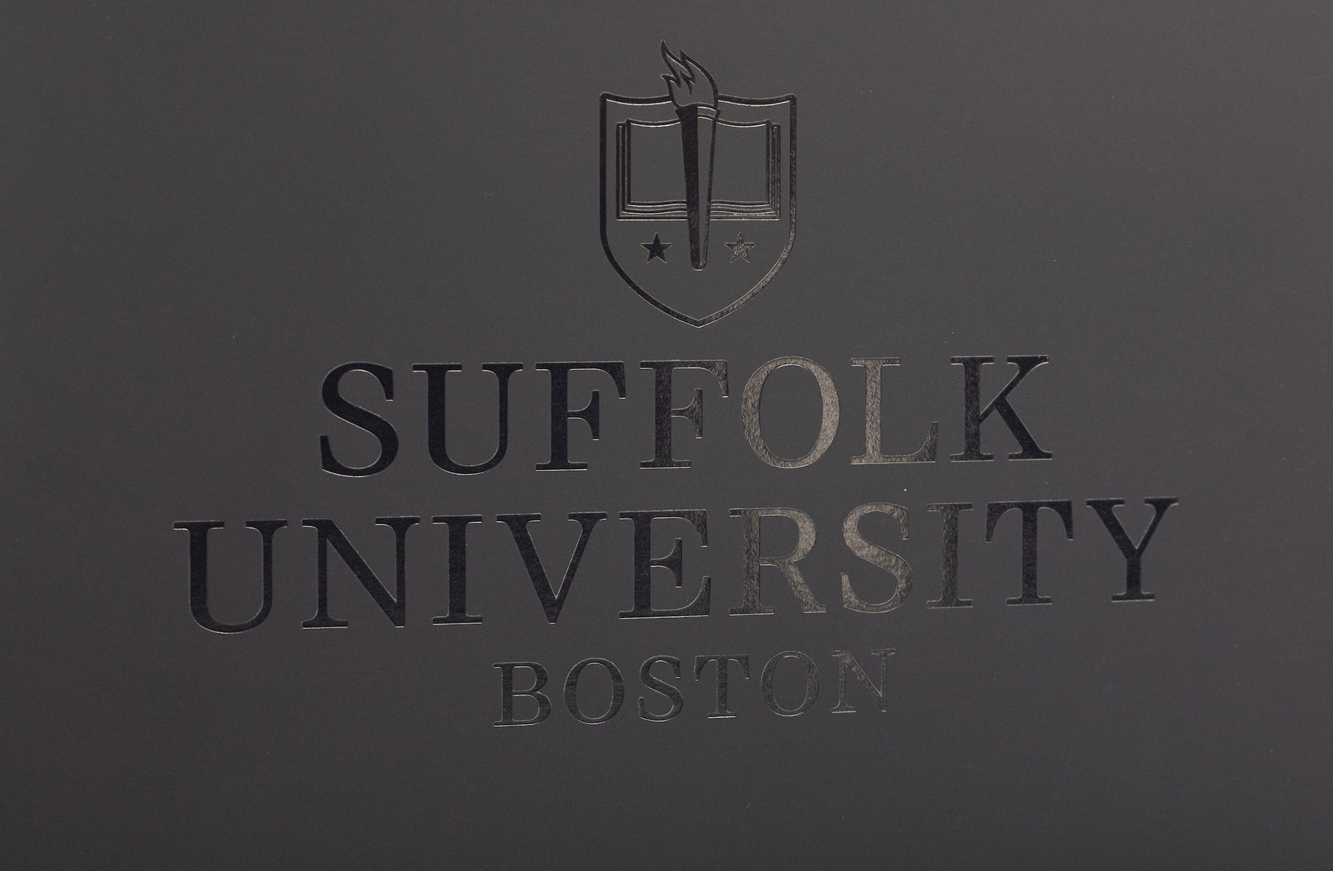 close up of the front cover of the folder showing the clear foil logo on soft matte paper