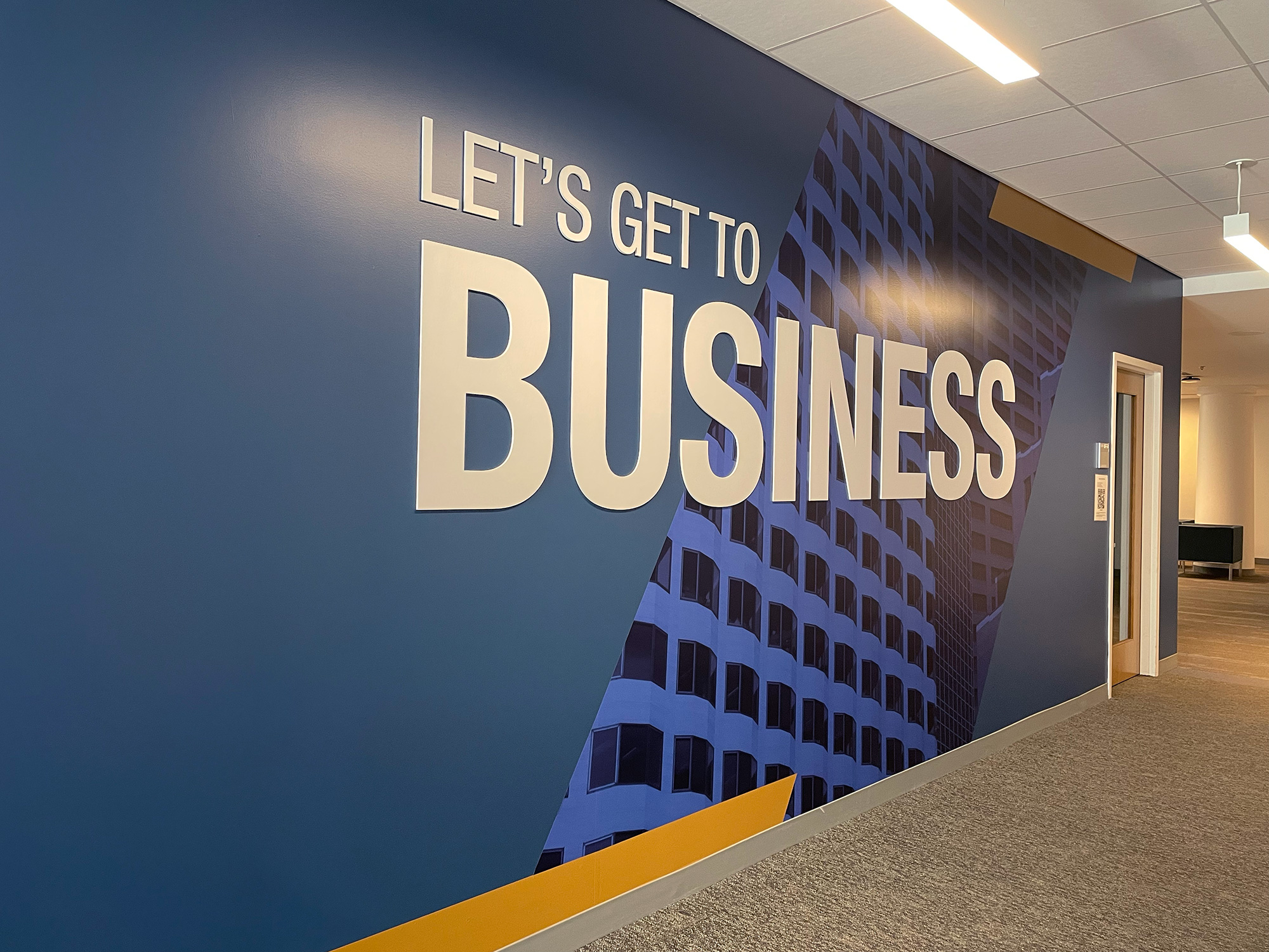 a closeup of skyscrapers in Boston with the phrase 'Let's Get to Business' on the wall