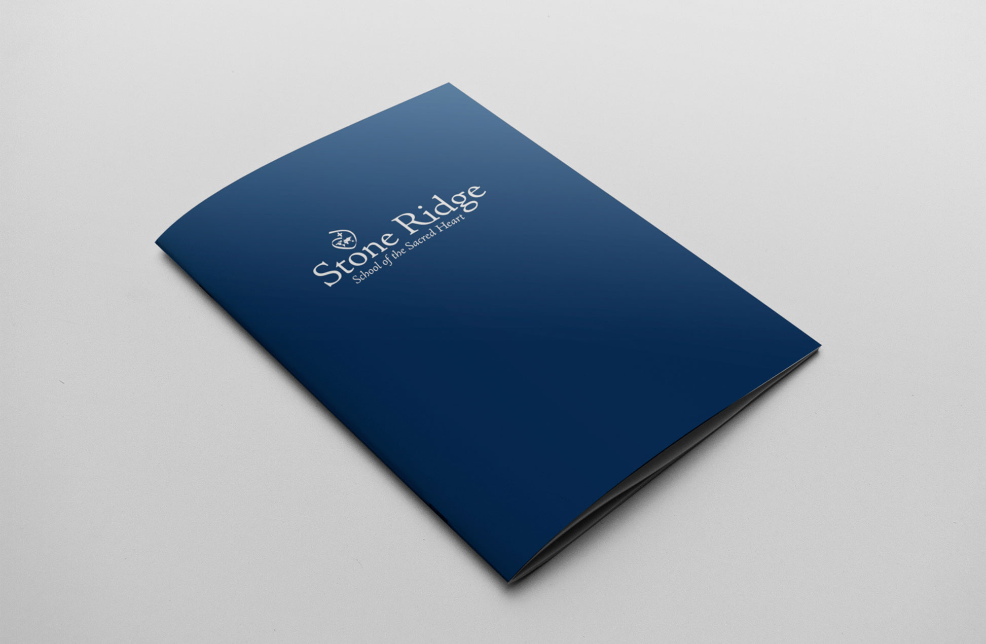 blue cover with the Stone Ridge School logo on the front